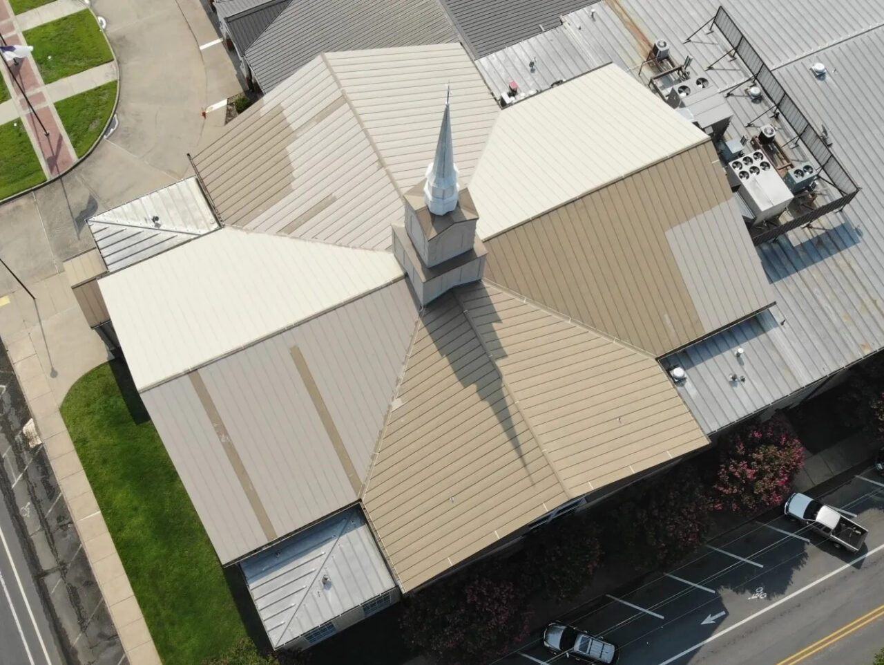 Commercial metal roof of a church before P.I. Roofing completed the repair